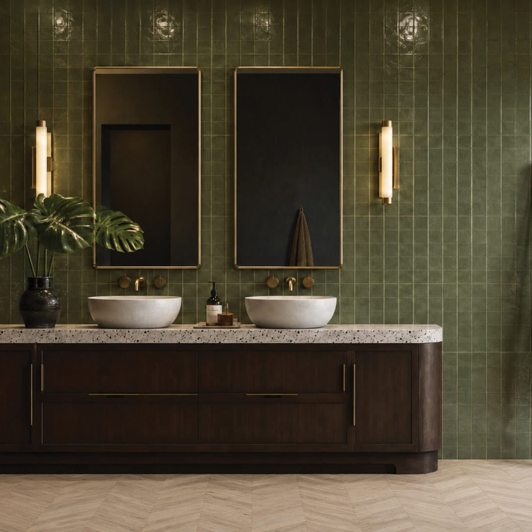 Luxury bathroom with Harbour Grid Cypress Gloss 400x800 deep green square-grid porcelain wall tiles and Duskwood Drift Chevron 75x450 timber look porcelain floor tiles, styled with brass mirrors, dark timber vanity and warm lighting.