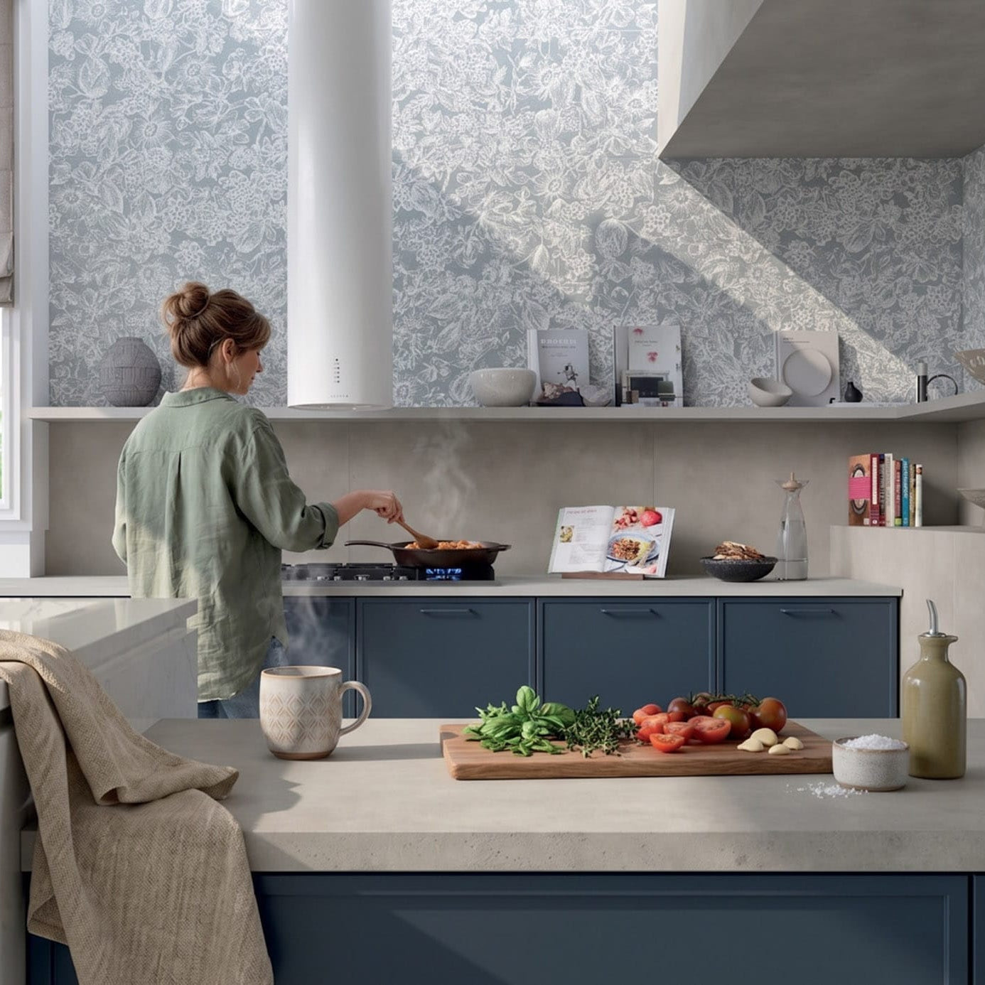 Modern kitchen with Wonderland Floral Bay Satin 500x1200 floral ceramic wall tiles and Symphony Moonlight Glow Matte 600x1200 concrete-look porcelain tiles on the lower wall and floor, styled with blue cabinetry.