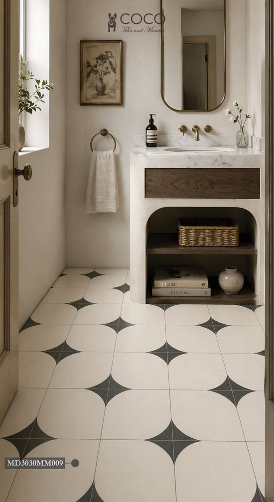 Small powder room with Arc After Dark Matte 300x300mm porcelain floor tile from COCO Tiles & Mosaics in warm ivory with fern green quarter-arc petal pattern, styled with a marble vanity, timber drawer, brushed brass tapware and arched mirror.