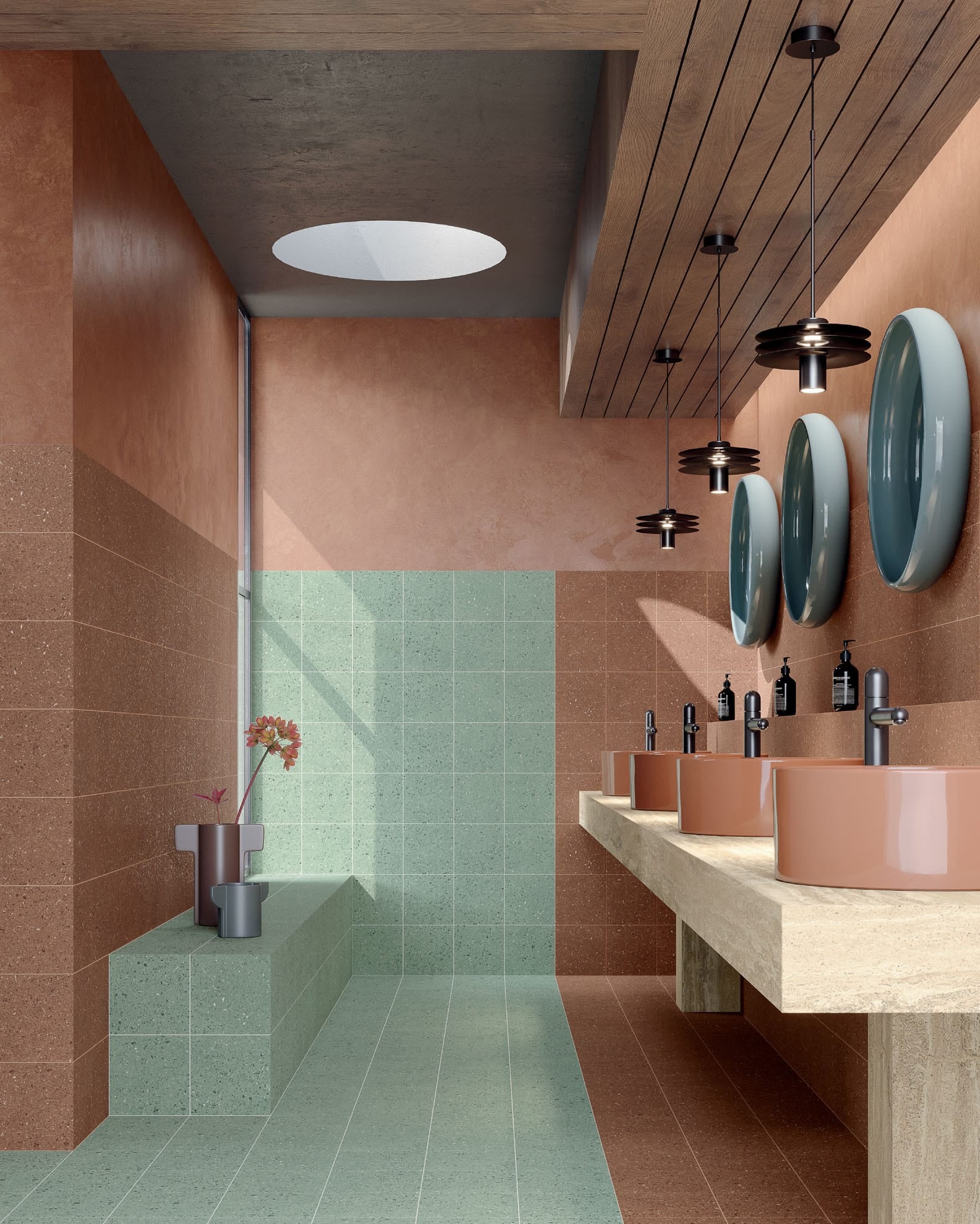 A bold, contemporary bathroom featuring the Bold Horizon tile look with striking colour-blocking. The walls feature Vogue Cotto warm terracotta 200x200mm tiles, while the floor and shower zone use Vogue Bamboo fresh mint green tiles. The space includes a floating raw stone vanity with terracotta vessel basins, matte black tapware, modern black disc pendant lights, and three large teal round mirrors.