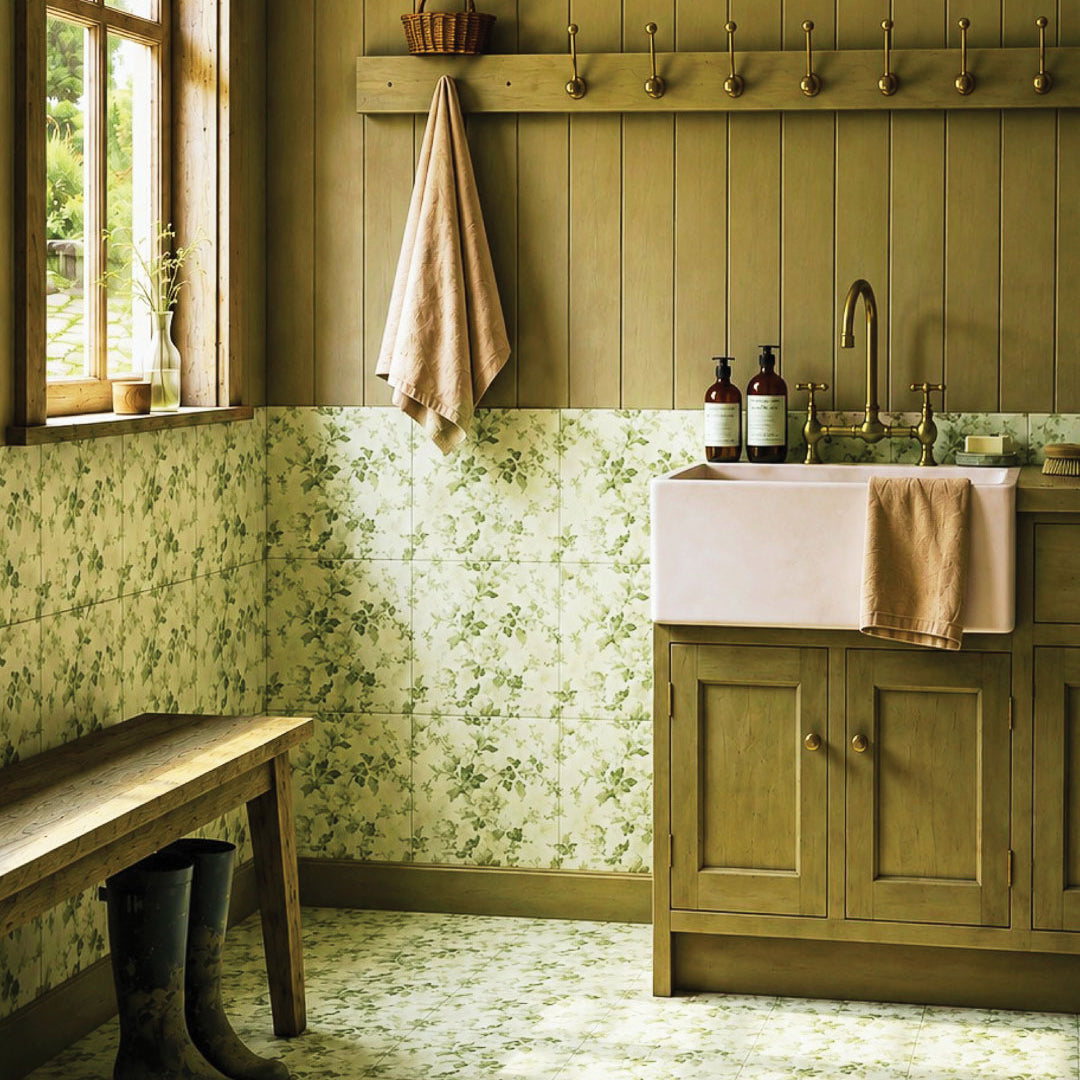 Country utility room with Red Room Garden Party Satin 300x300 ceramic tiles featuring soft sage floral vines on an ivory base, styled with sage joinery, farmhouse sink, brass tapware, timber bench and muddy boots.