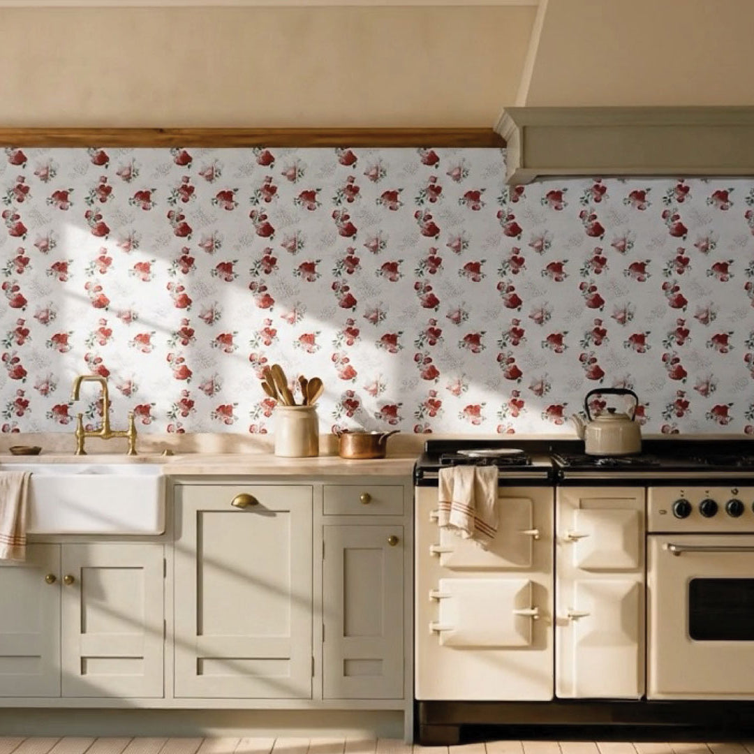 Country kitchen with Follow Your Heart crimson and blush peony floral ceramic splashback, sage green shaker cabinetry, stone benchtop, white butler sink, brass tapware and a cream range cooker.