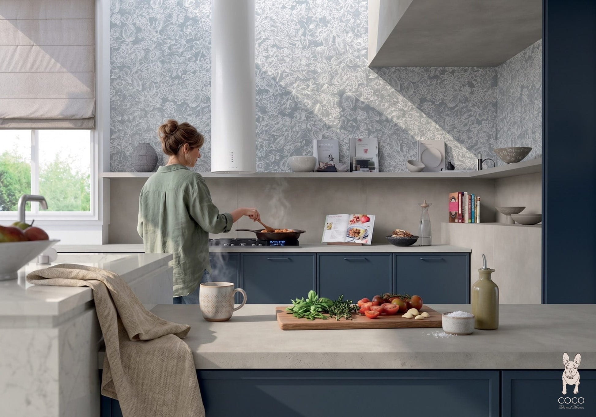 Modern kitchen with Wonderland Floral Bay Satin 500x1200 floral ceramic wall tiles and Symphony Moonlight Glow Matte 600x1200 concrete-look porcelain tiles on the lower wall and floor, styled with blue cabinetry.