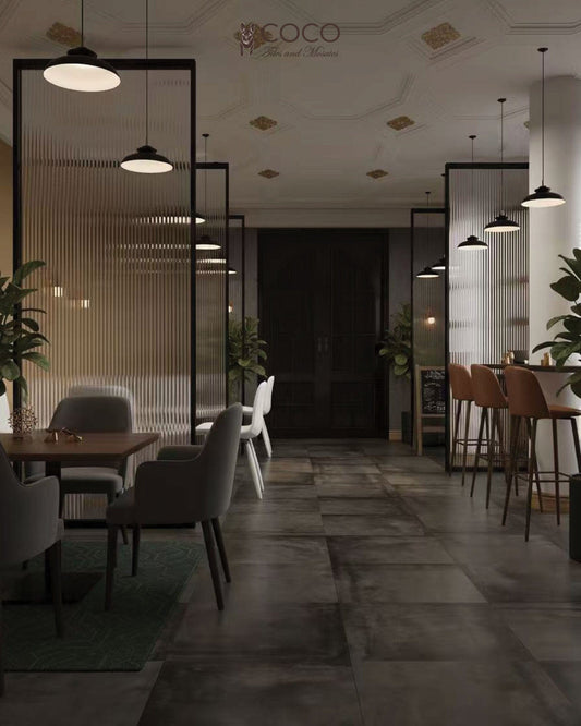 Black Card Lounge & Bar interior with ribbed glass, warm bar stools and large-format Blend Series Graphite Natural 592×592mm concrete-look porcelain floor tiles.