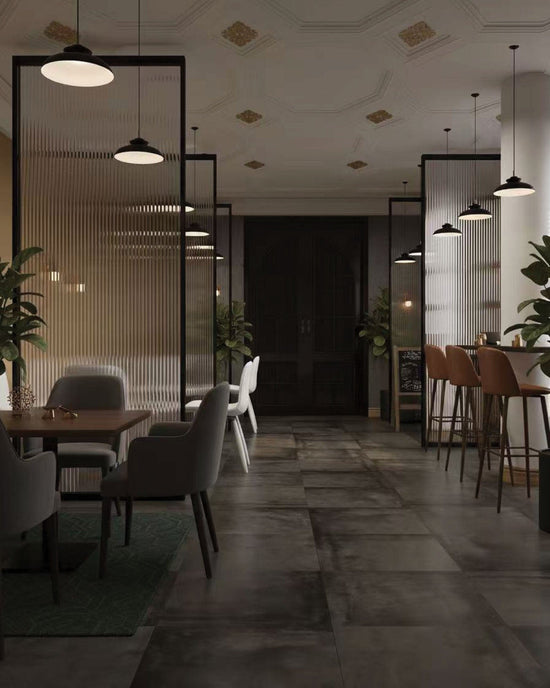 Black Card Lounge & Bar interior with ribbed glass, warm bar stools and large-format Blend Series Graphite Natural 592×592mm concrete-look porcelain floor tiles.