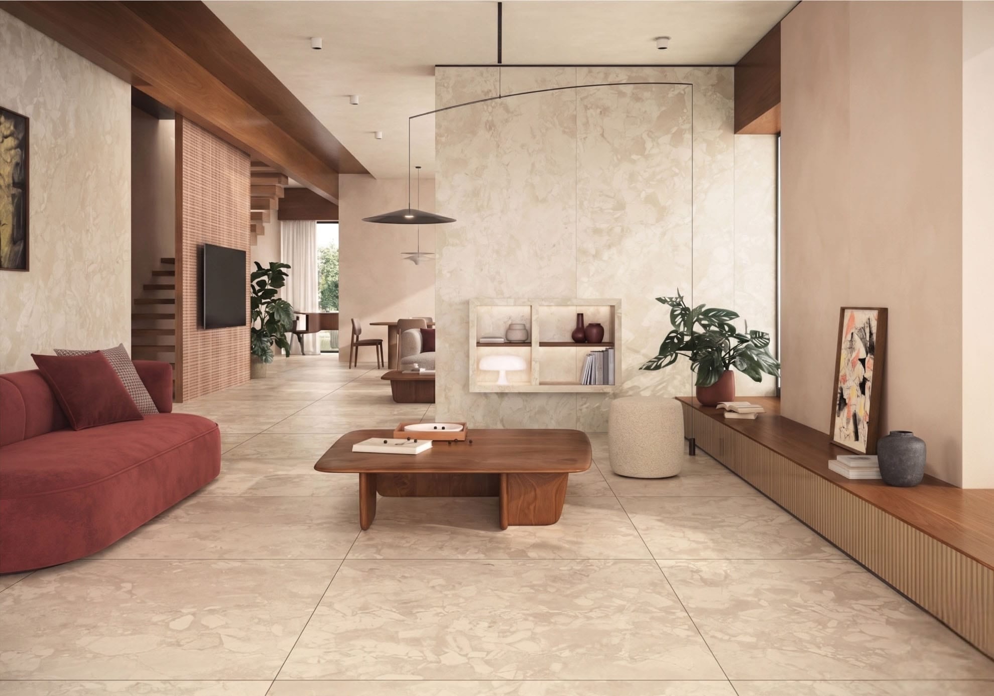Open-plan living room with Fragmenta Series Cappuccino matt 600x600 terrazzo-look porcelain floor tiles in warm beige tones, styled with walnut timber joinery and modern furnishings.