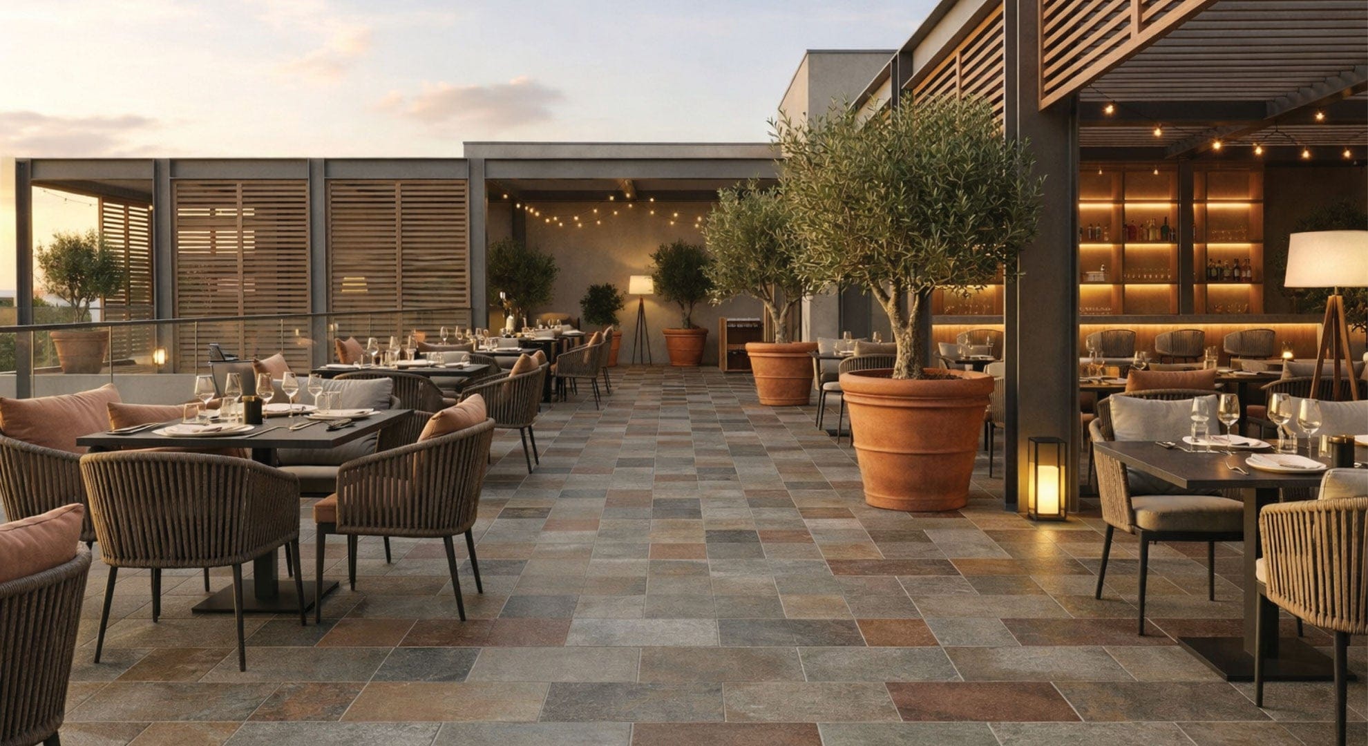 Rooftop dining terrace featuring Arcadia Valley Crest 225x453mm textured porcelain tiles in warm rust and grey tones laid in a staggered brick pattern.