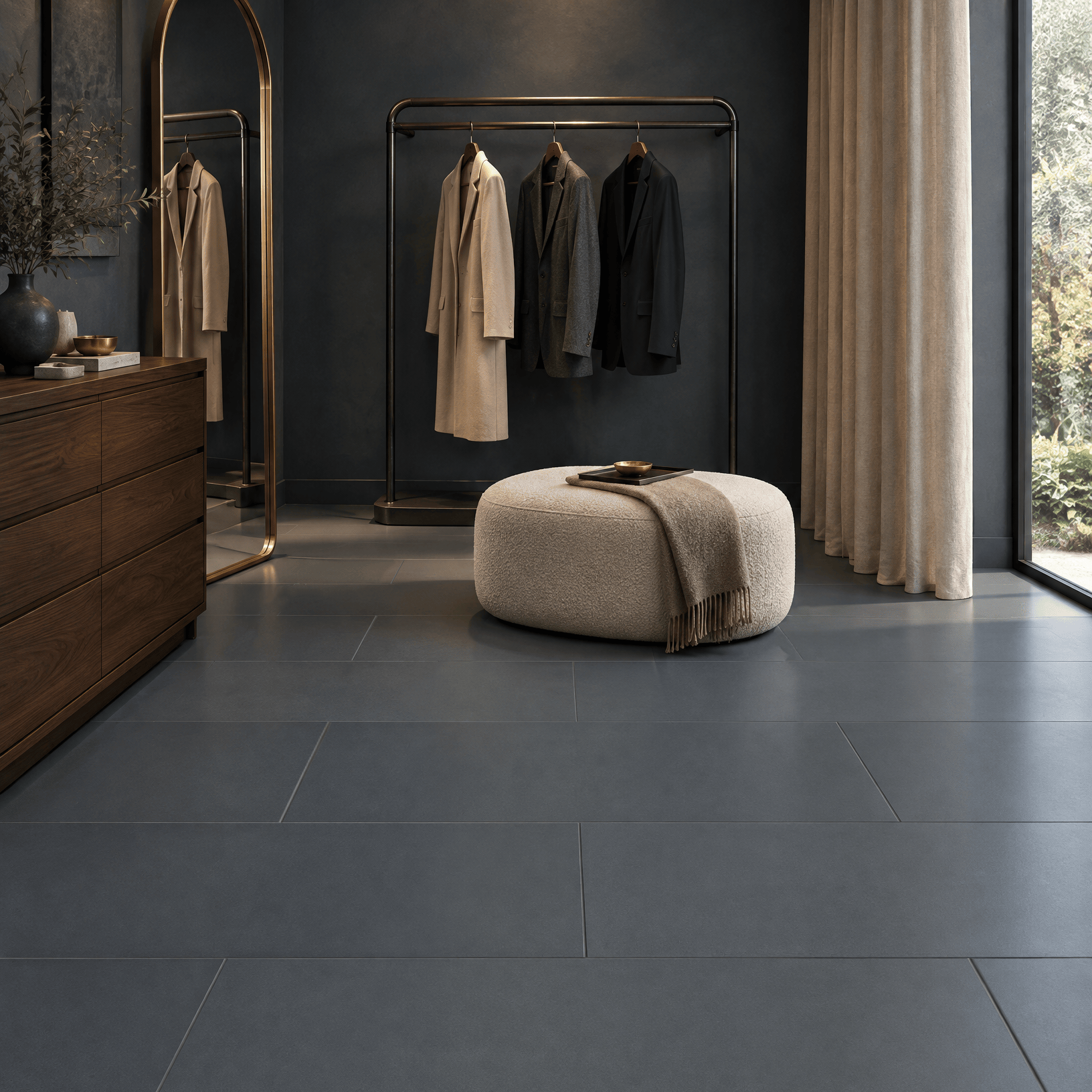 Deep Space blue-grey porcelain floor tiles in a private fitting room with a full-length mirror, dark timber dresser and cream ottoman.